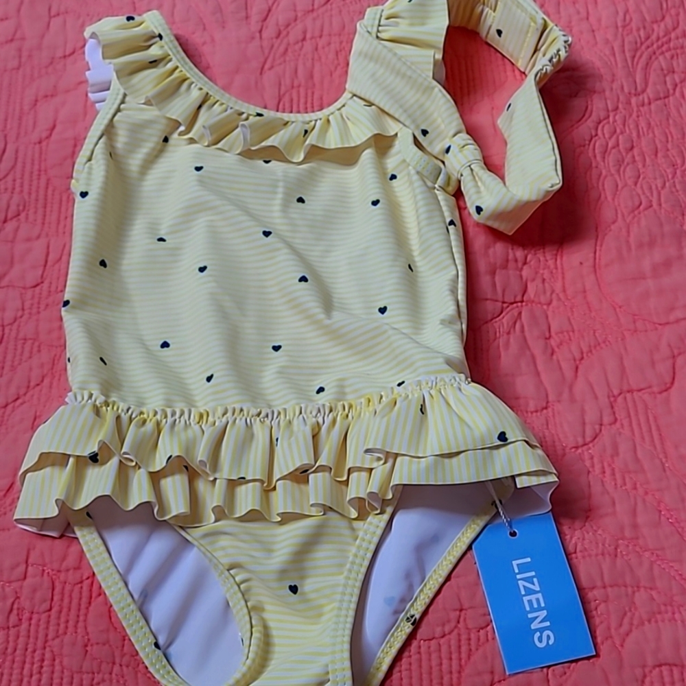 Absolutely adorable toddler girl's swimsuit. Ruffles around the Botto and neck